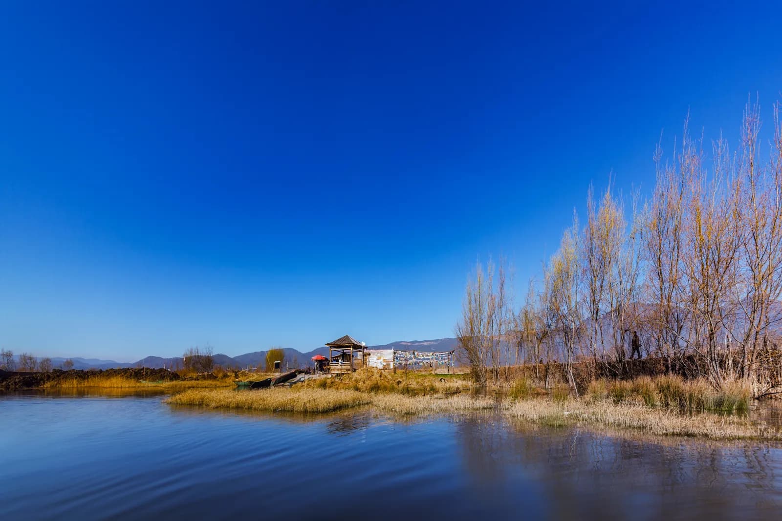 Quiet shoreline and pavilion on Lugu Lake in northwest Yunnan