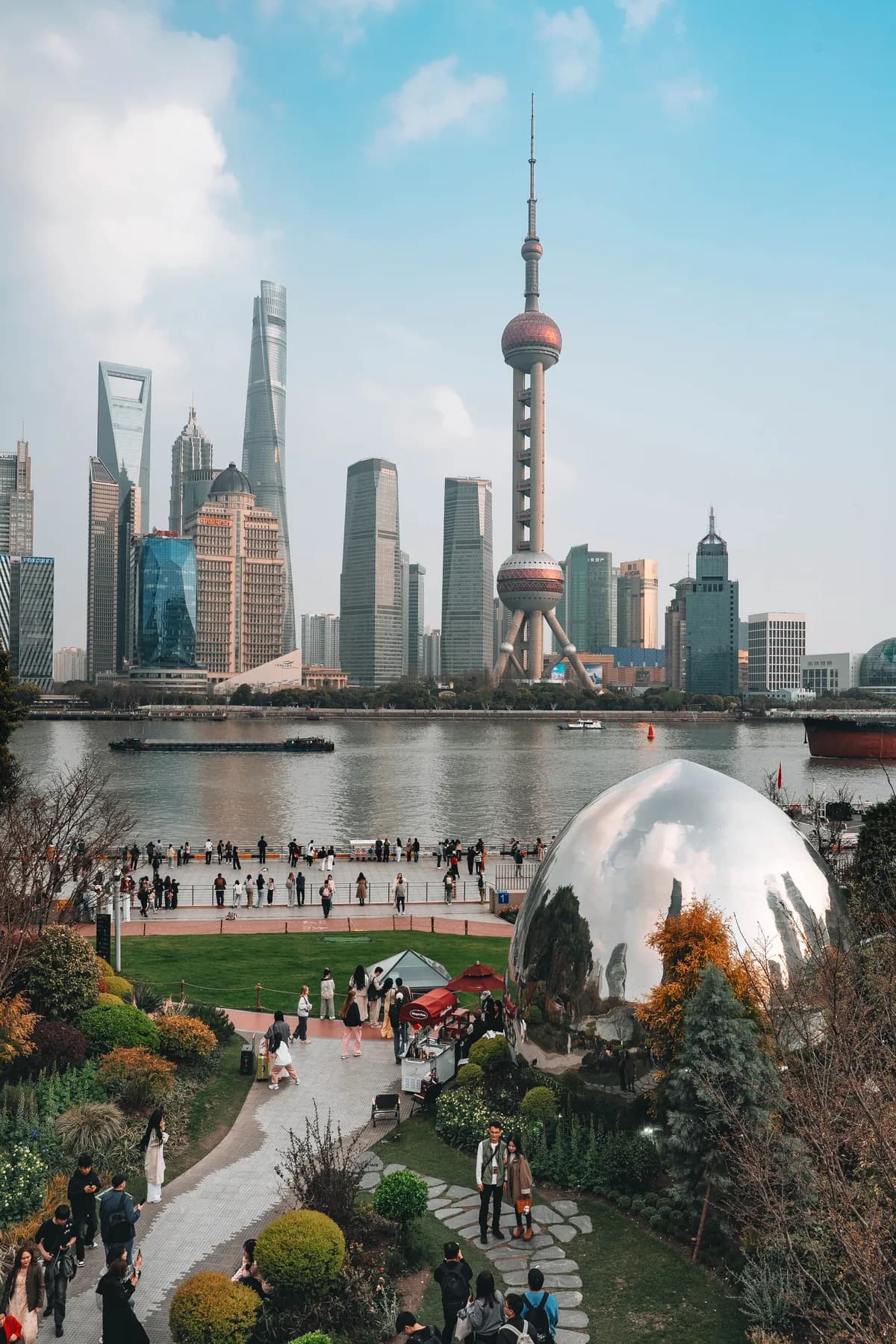 Shanghai skyline across the Huangpu from a riverside park